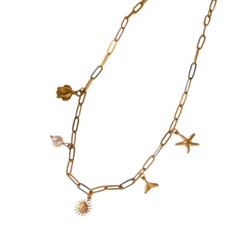 Multi Bedelketting goudkleurig &acirc;&euro;&ldquo; parel & zeethema - Dames