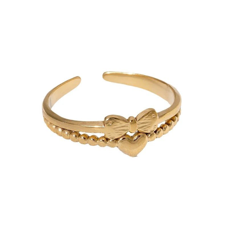 Stalen Damesring - Strikje & Hartje - 7mm - Goudkleur -