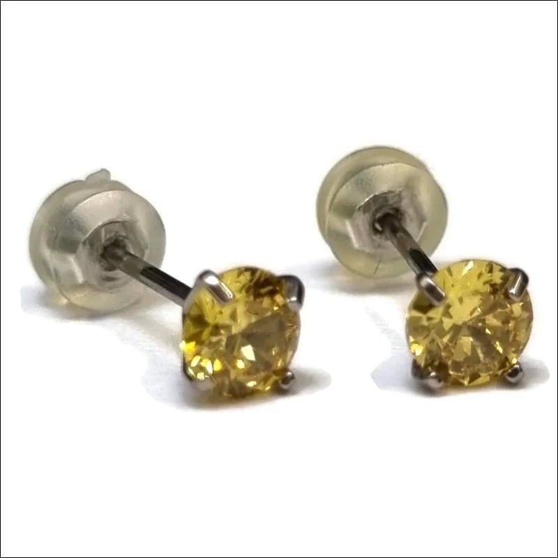 Ronde Titanium Oorbellen met Gele Zirkonia van Aramat -